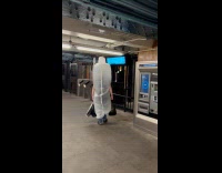 Guy wears inflatable condom walks on subway