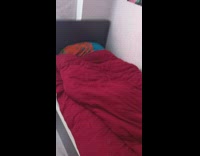 Guy hide tucked in under red blanket