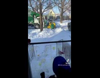 Mom and little boy watch garbage truck