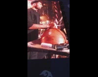 Man playing calabash instrument at concert 