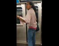 Woman wears pink lace thong outside of her jean pants and dances on the subway