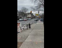 Guy wearing boba fett mask walks sidewalk 
