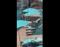 Woman in blue bikini tiktok dance by the beach