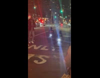 Two men rides go kart on street