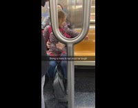 Little girl riding train reaches for pipe