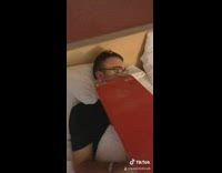 Guy sleeps in bed with budweiser box 
