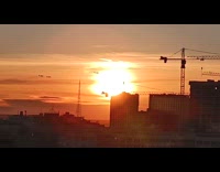 Planes and contrail silhouette pass by sunset