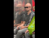 Collab WINY - Man holds joystick plays PlayStation in subway