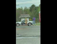 Woman in yellow bikini dances at the parking lot