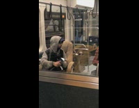 Man reads paper out of his binder and closes it after guy behind him leaves