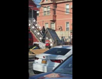 Four guys carry grey bed frame upstairs 