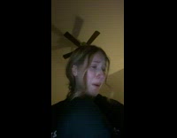 Orange cat biting on to girls wrist 