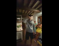 Guy hits beer bottle bottom to open 