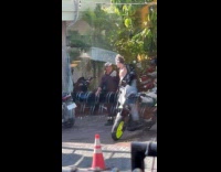 Man with bouncy shoes films on sidewalk