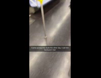 Red shirt guy backpacks on floor subway