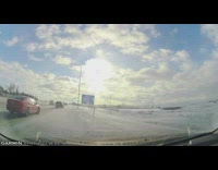 Guy drives off icy road on freeway