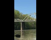 White shirt girl leaps dances bridge lake
