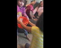 Two kids fight over bucket of money 