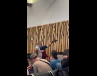 Couple headstand formation inside the airport lobby