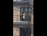 Guy outside on balcony with ring light 