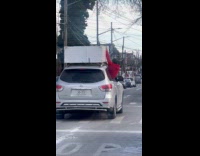 Guy out of window hold furniture over car