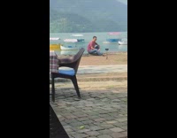 Guy shirt sit raise arms tripod boat