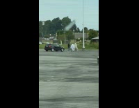 Two people dressed like ghosts dance tripod 