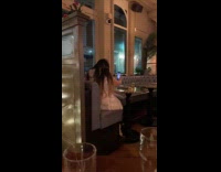 Woman fur coat selfie time lapse inside restaurant