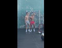 Two shirtless guys pose with their abs 