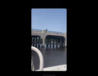 Blue shorts guy triple backflip bridge water