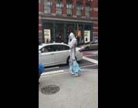 Guy white hazmat suit covered in masks 