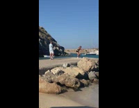 Woman jump workout video shoot beach dock