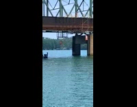 Happy orange traffic cones under bridge lake 