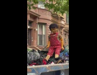 toy doll sitting up on top of trash pile