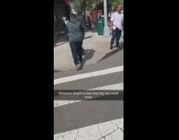 Man yells out loud at pedestrians while holding the Bible and a composition book