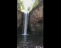 Guy jumps off cliff waterfall water friends