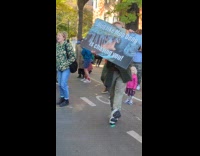 Man dances with signage at the Marathon
