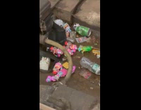 Dolls toys and trash on train tracks