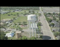 Large white water tower falls down drone
