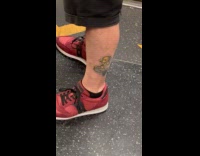 Man rides train with  leg mermaid tattoo