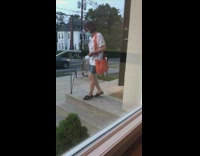 Woman red dress bag outside restaurant bench