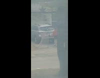 Woman red jacket tiktok video across street