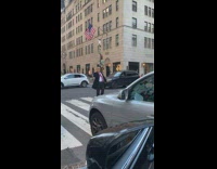 Guy trump mask suit stands crosswalk cars