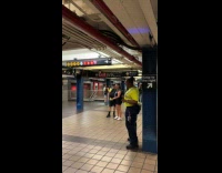 MTA worker jamming to man playing saxophone