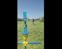 Guy uses whip to knock away small bottle cap