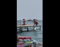 Woman remove red bra straps behind the beach 