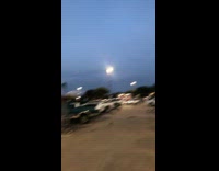 Flock of birds over parking lot cars