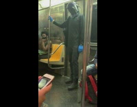 Guy wears helmet and gloves on train 