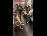 Guy does breakdance in train aisle 
