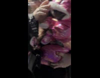 Woman carrying dog wearing puffer jacket